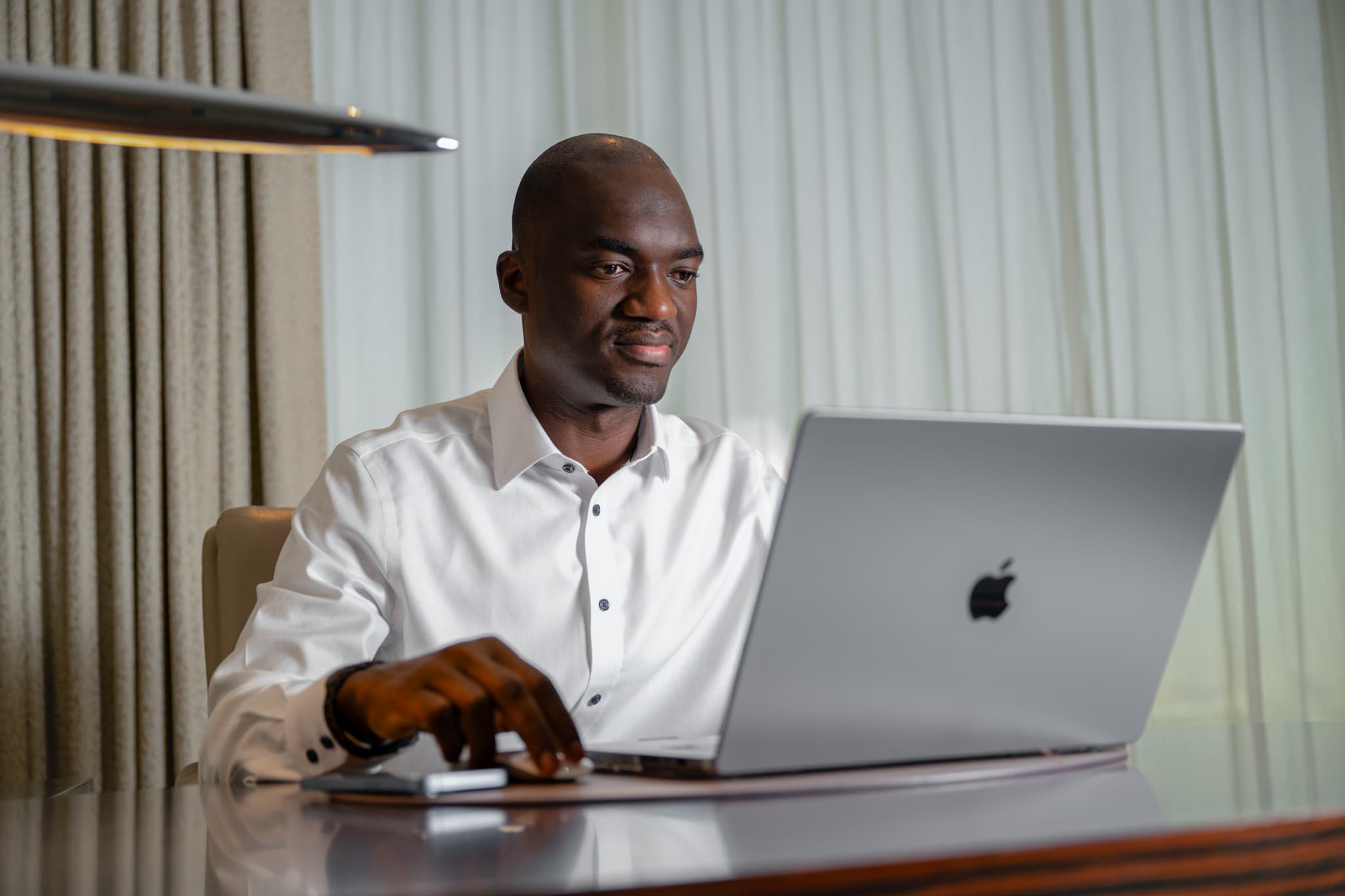 Tunde Cole working at a laptop